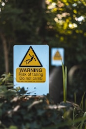 warning risk of falling do not climb signage