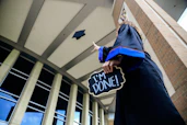 low angle photo of woman standing and holding I'm done signage