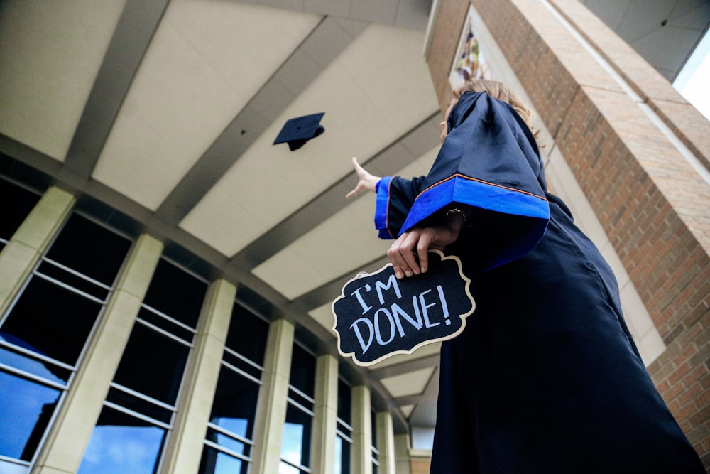 low angle photo of woman standing and holding I'm done signage