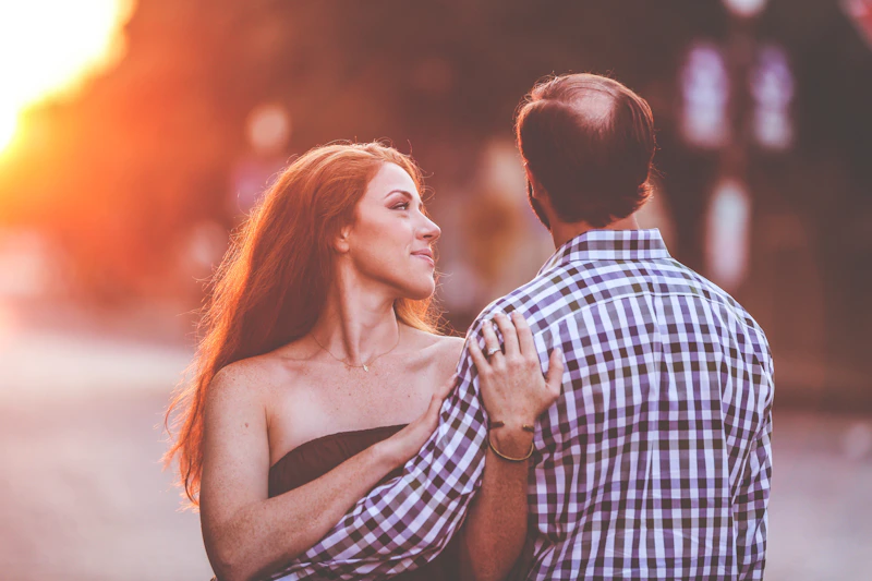 man and woman standing together on a road