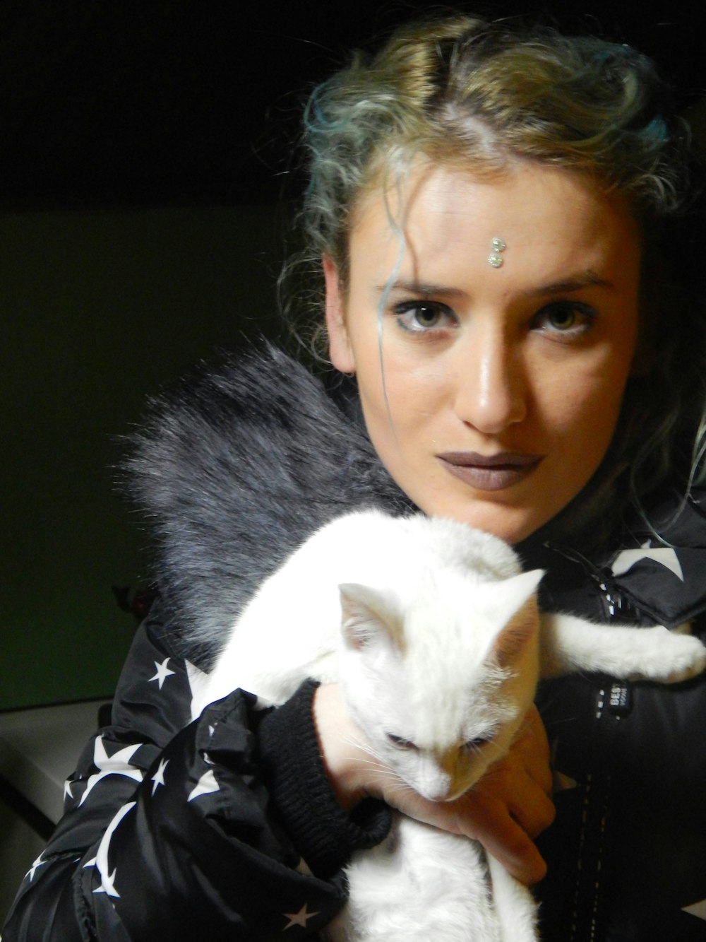 woman holding white cat