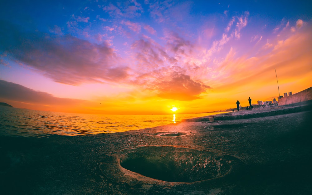 body of water during sunset