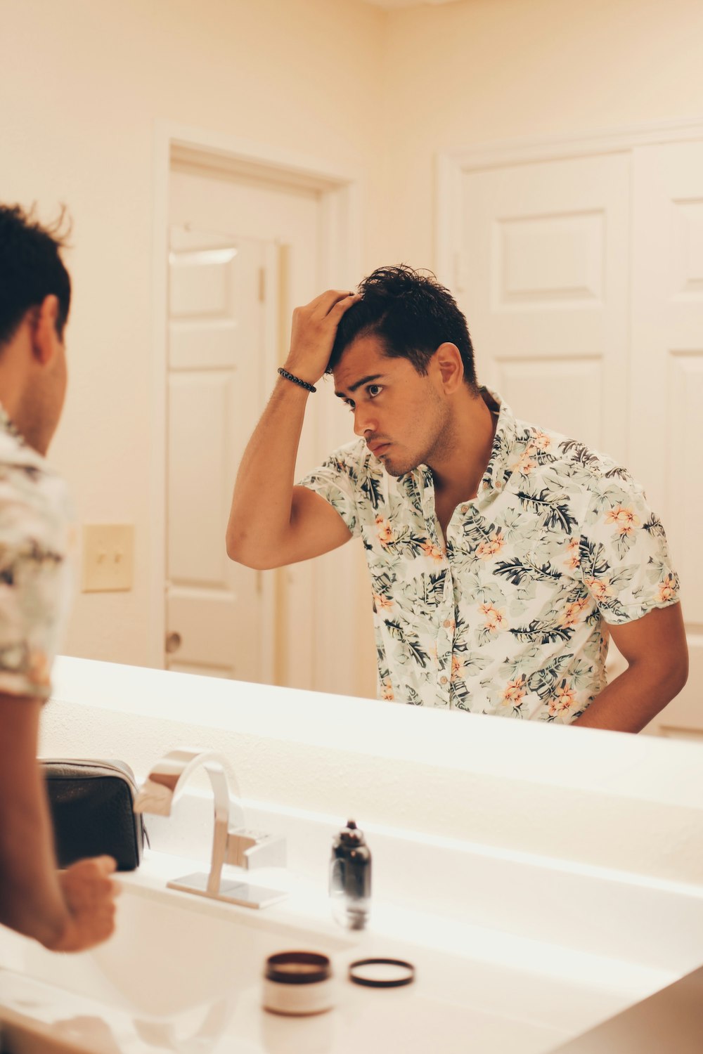 man standing in front of the mirror