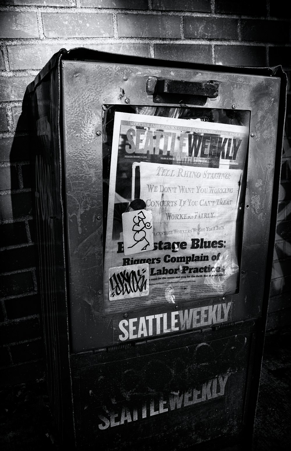 grayscale photography of a Seattle Weekly newspaper machine