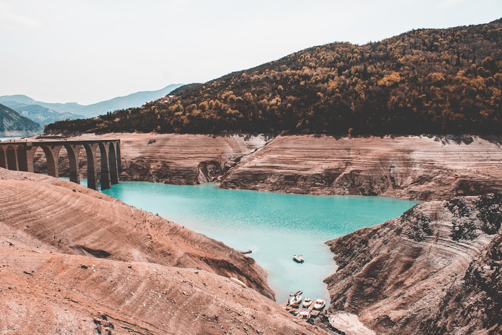 clear blue water surrounded by rock formation during daytime