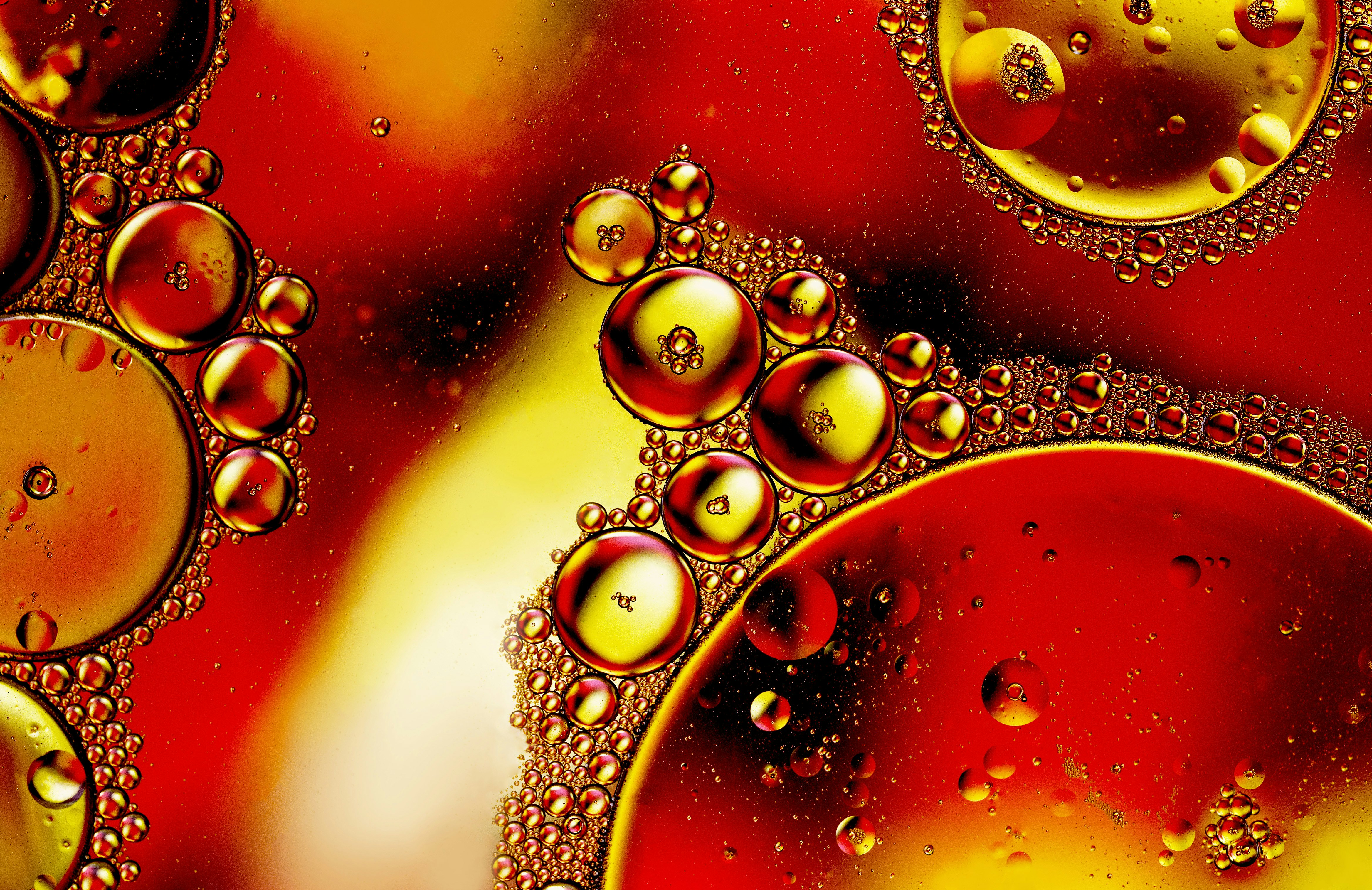 a close up of water bubbles on a red surface