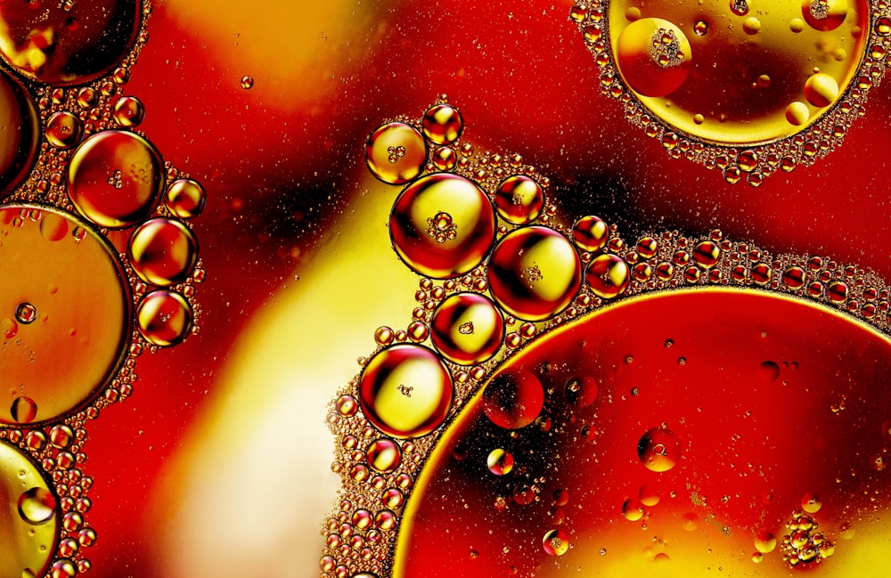 a close up of water bubbles on a red surface