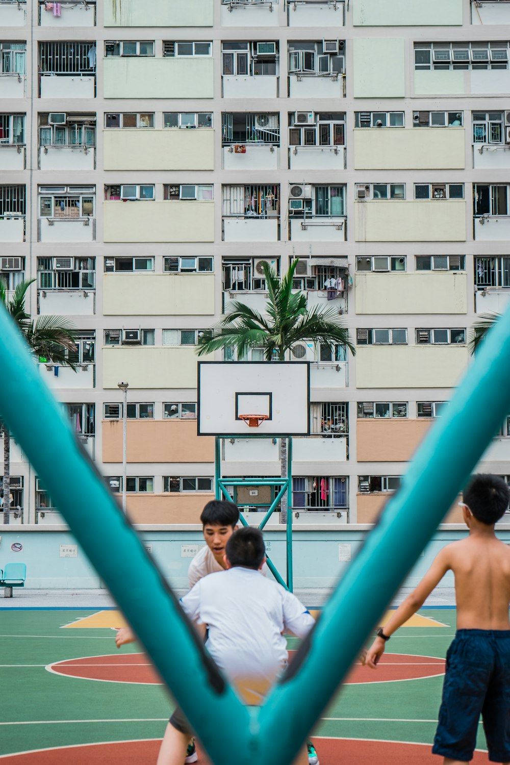 group of people playing basketball during daytime