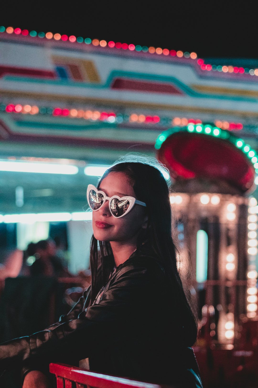 smiling woman wearing sunglasses at night
