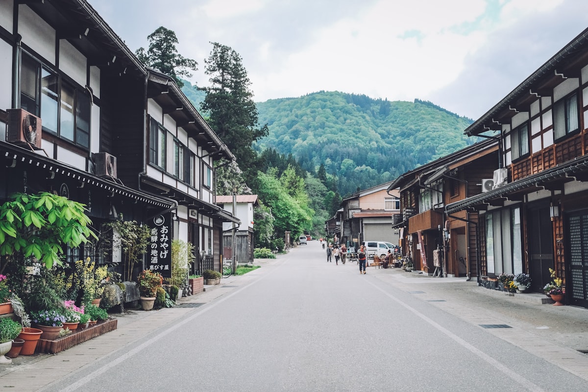 Naramachi preserved merchant district — traditional white-walled machiya townhouses along a narrow lane