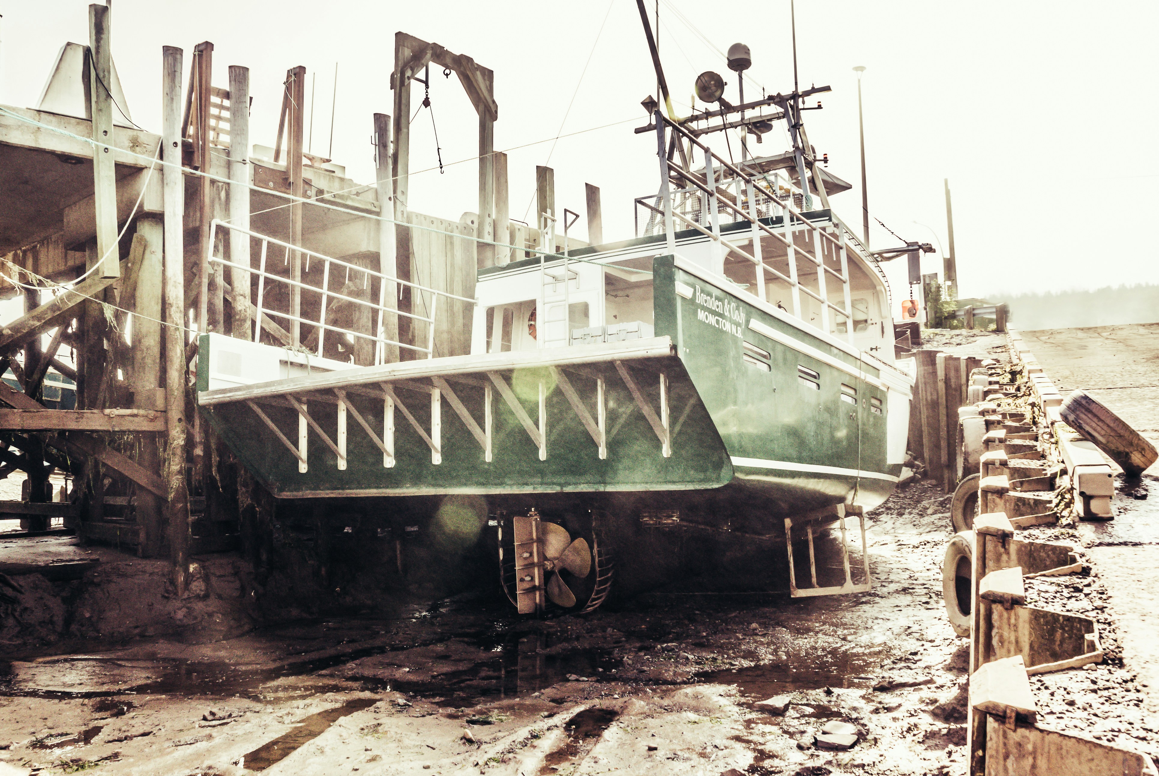 A marine construction barge with equipment working on a shoreline, illustrating heavy machinery - Babylon, NY Marine Construction