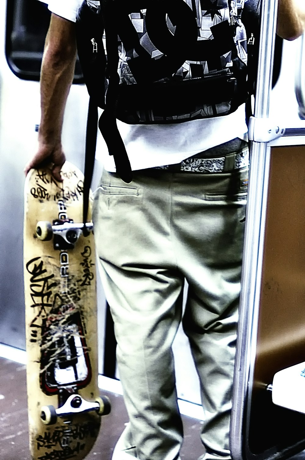 unknown person holding brown skateboard