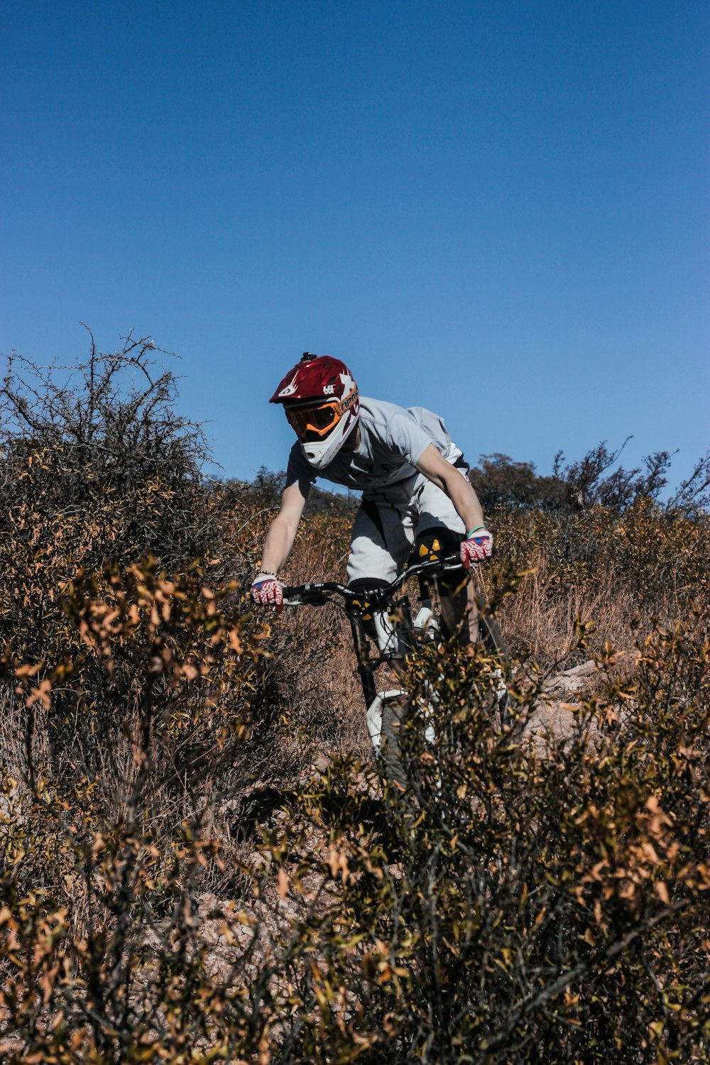 man riding bicycle and treading down a mountain slope