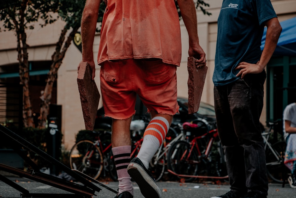 man carrying two concrete slabs