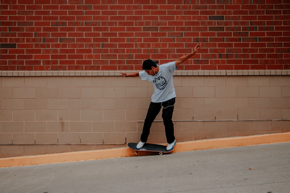 man doing skateboard tricks on sidewalk