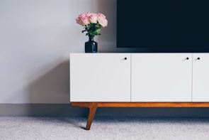 Minimalist white TV unit integrated seamlessly into a modern European style interior.