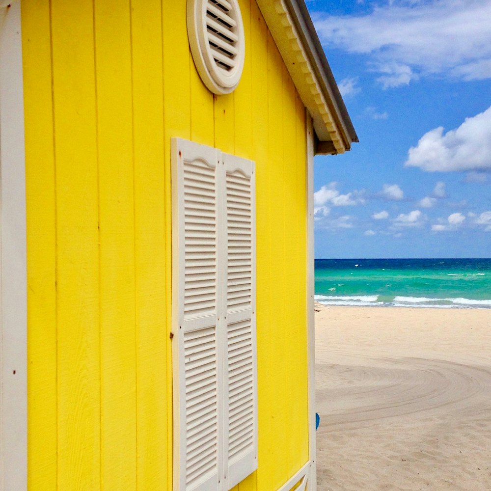 yellow and white wooden cottage