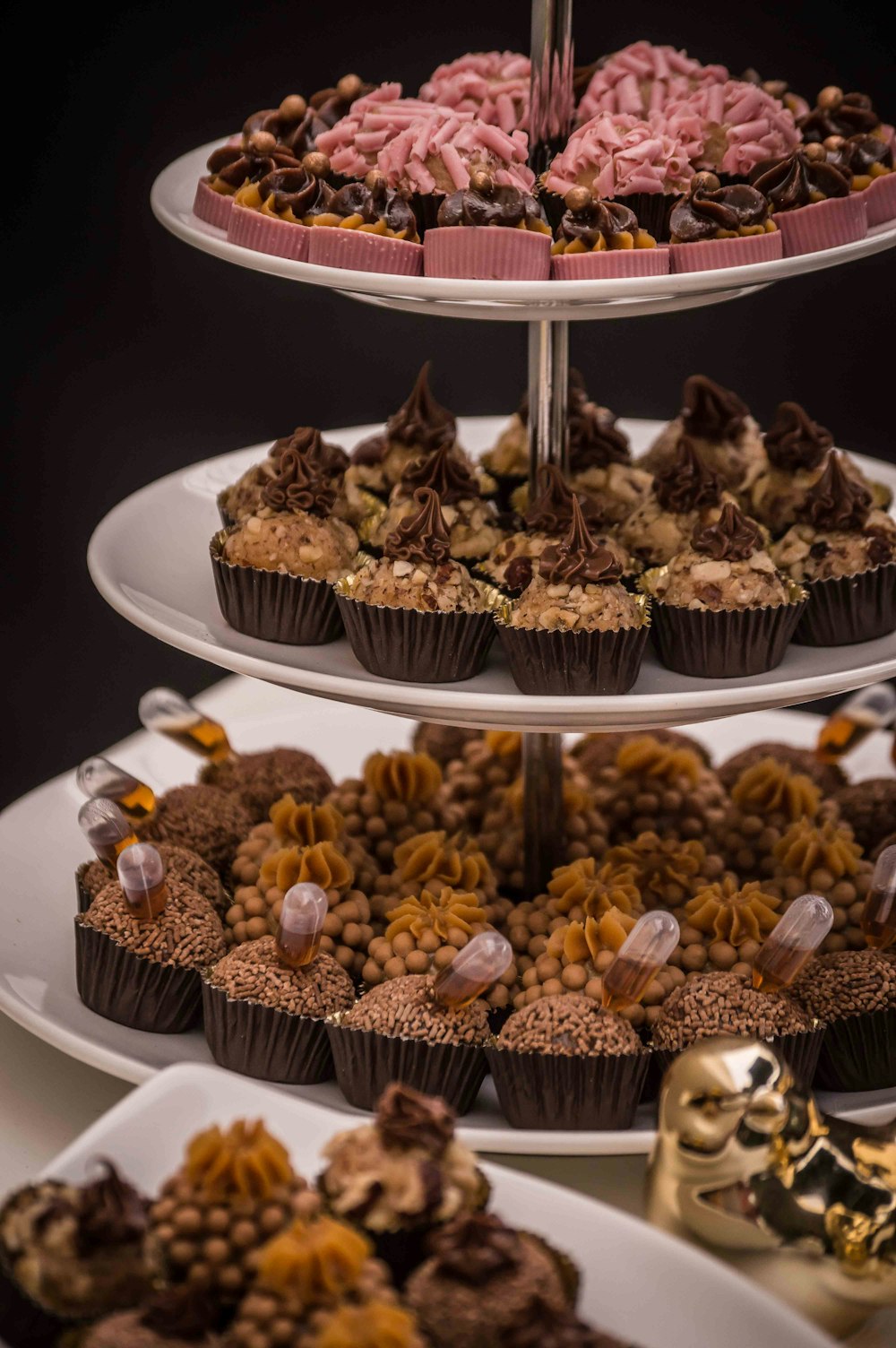 variety of cupcakes on cupcake rack