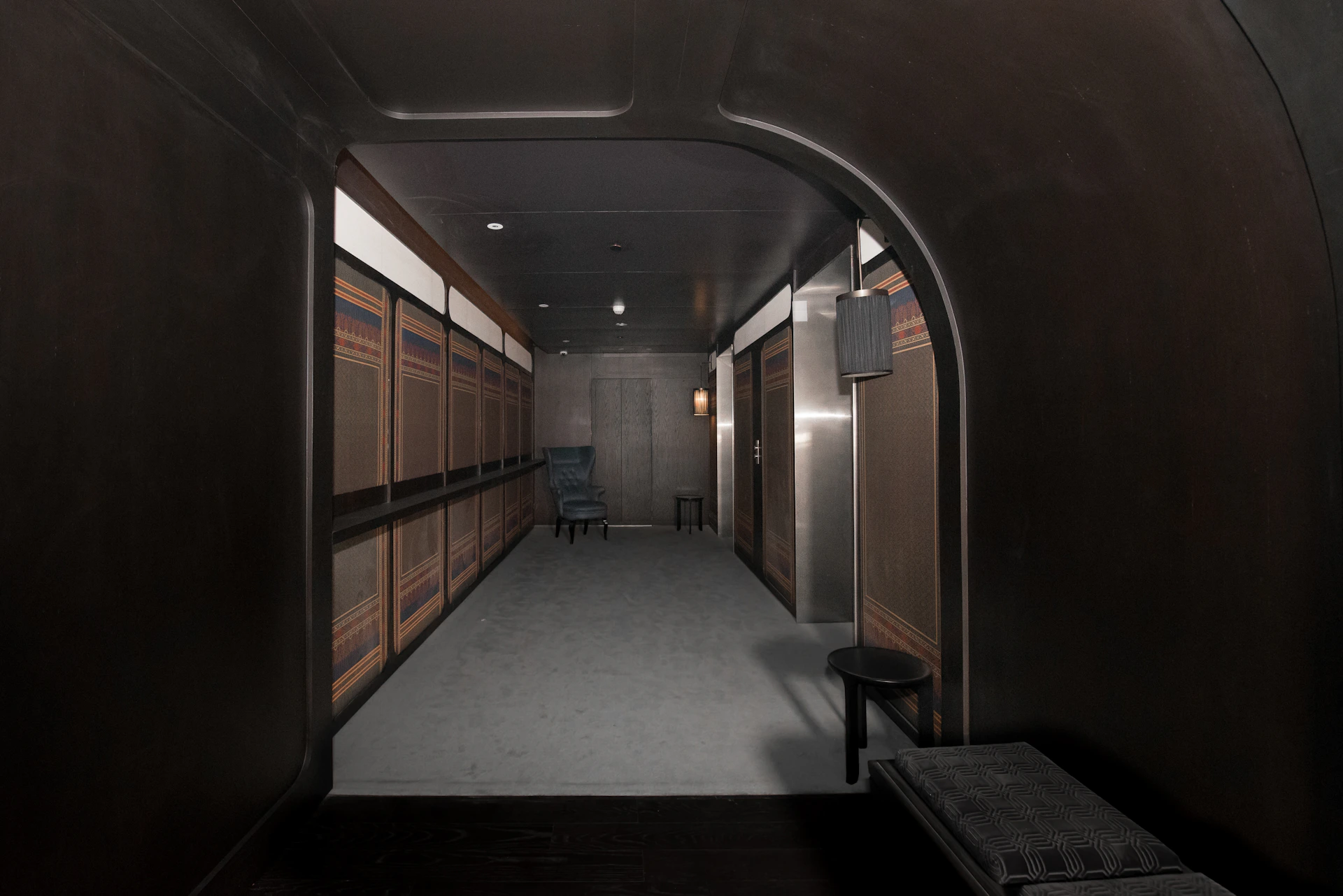 a long hallway with a bench and a chair