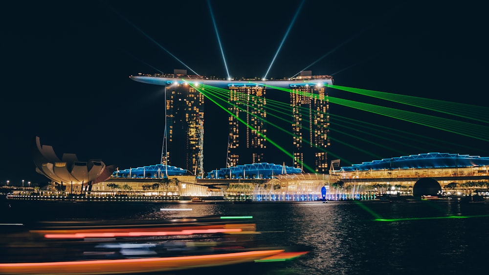 lighted high-rise buildings near body of water