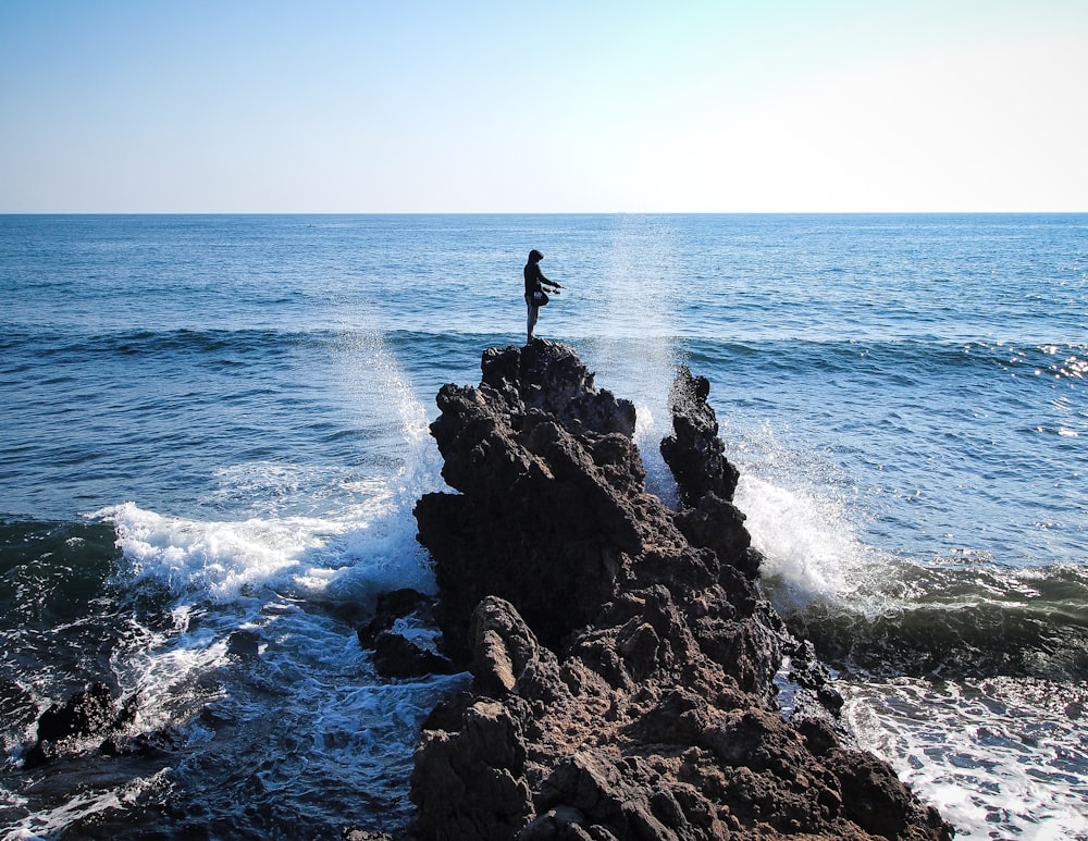 man standing on cliff