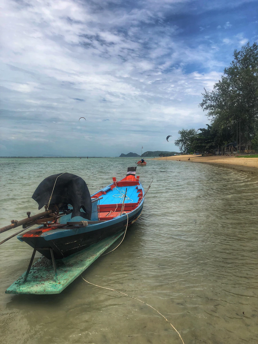 A longtail boat pulled up on the shore of a Koh Phangan beach