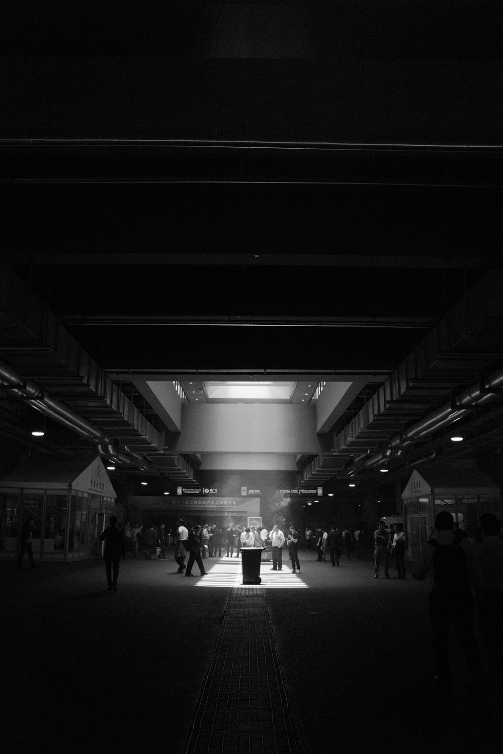 a black and white photo of people in a building