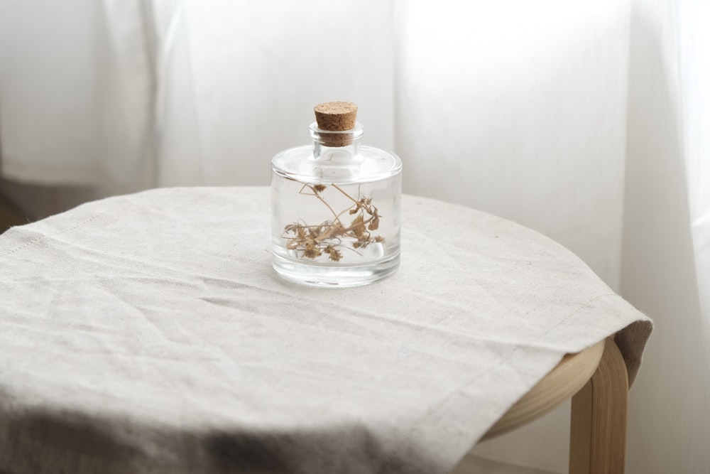 garrafa de vidro transparente na mesa