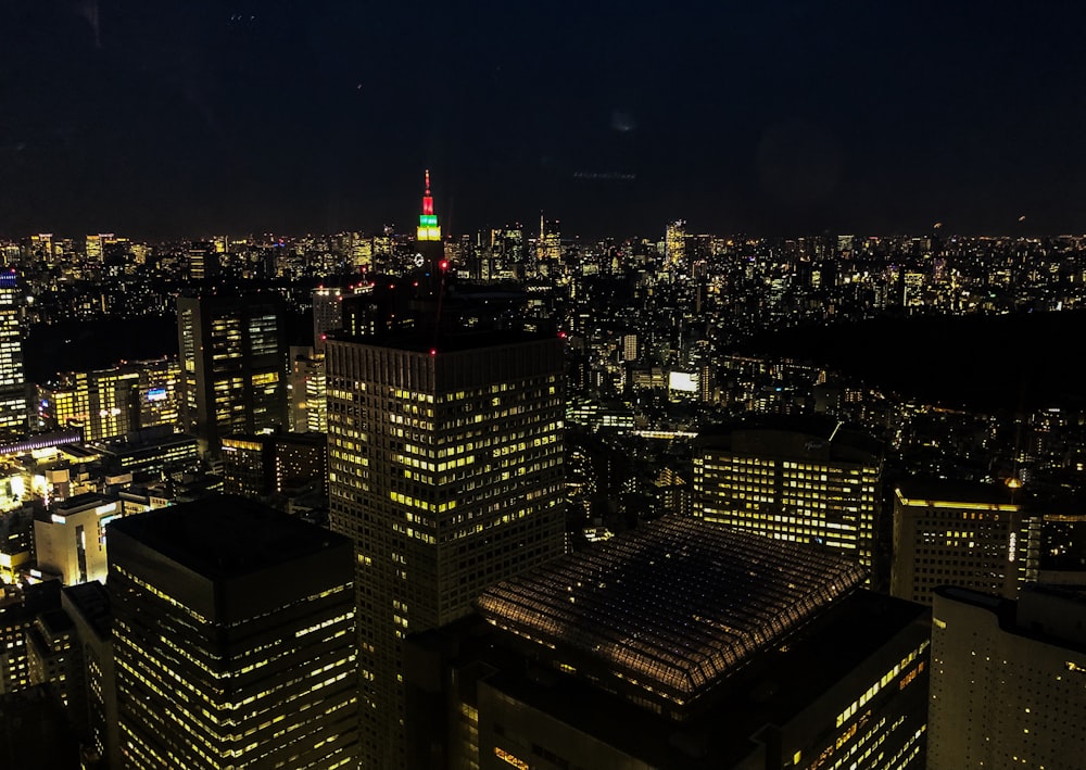 tall building lot during nighttime with lights