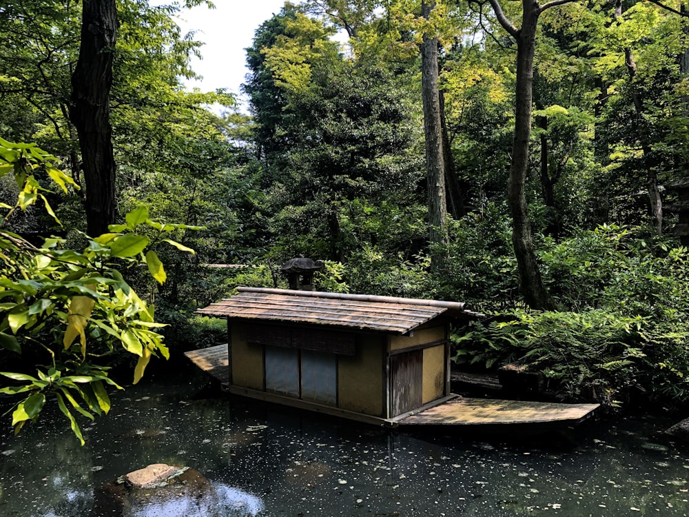 brown wooden house near trees at daytime