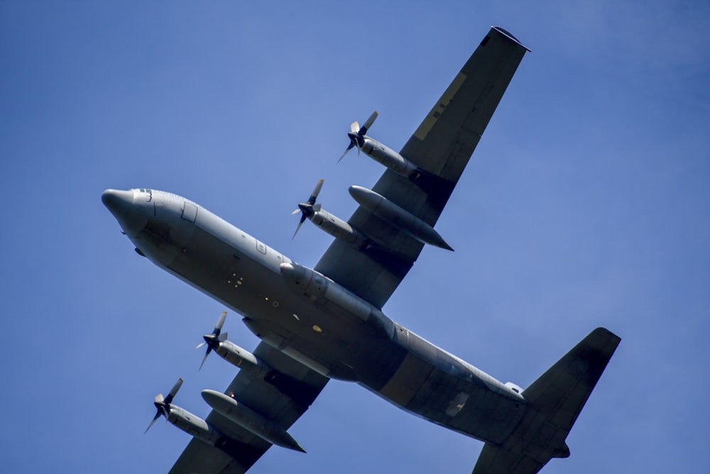 blue plane in sky during daytime