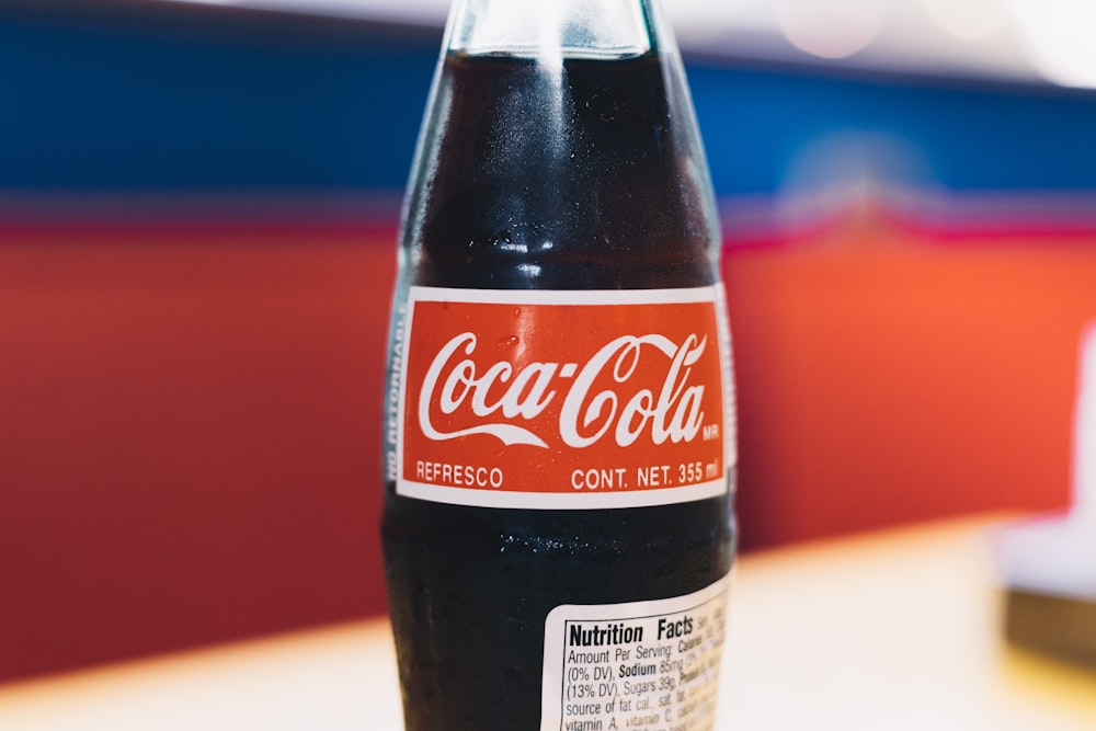 shallow focus photo of Coca-Cola soda bottle