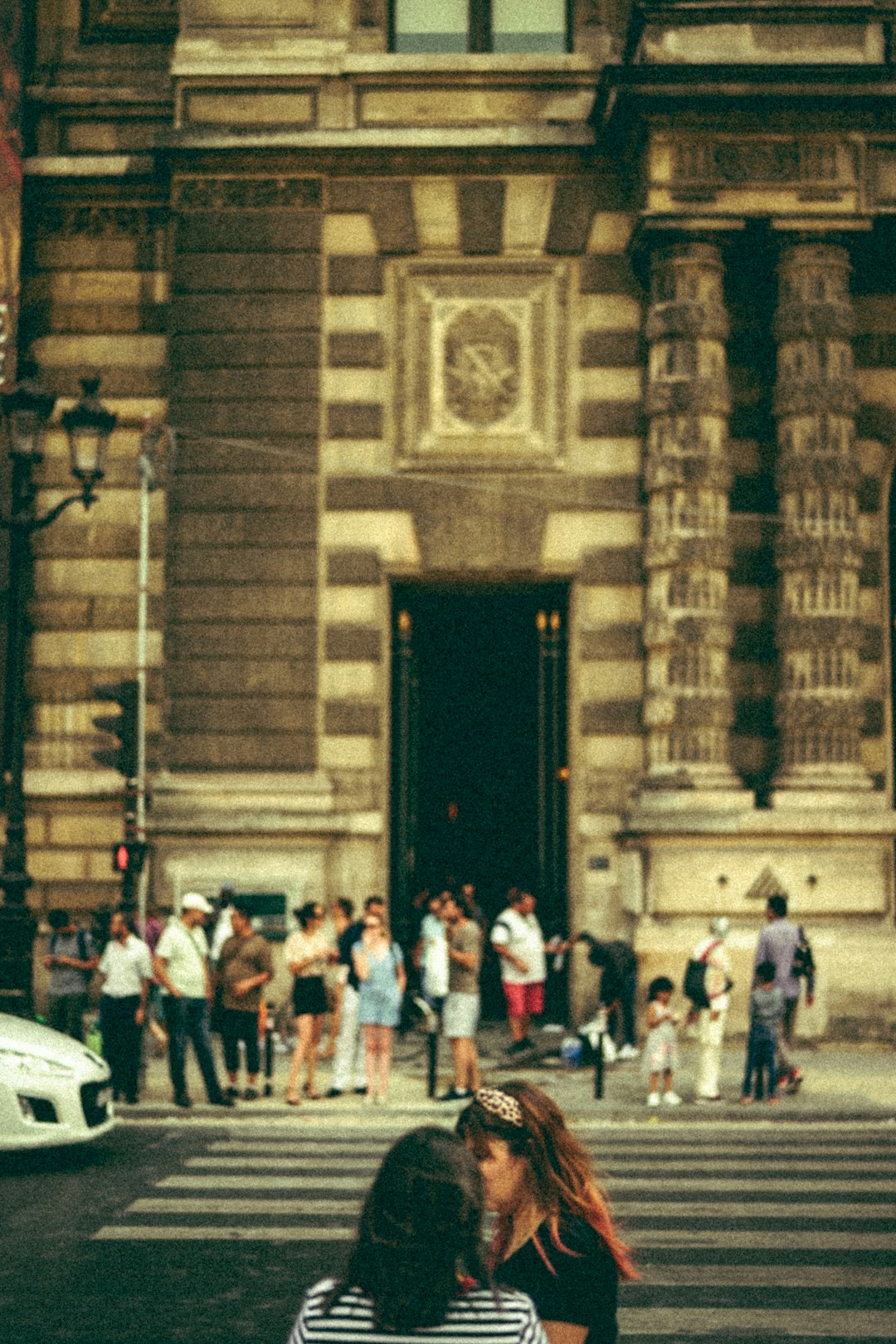 people standing near brown concrete building