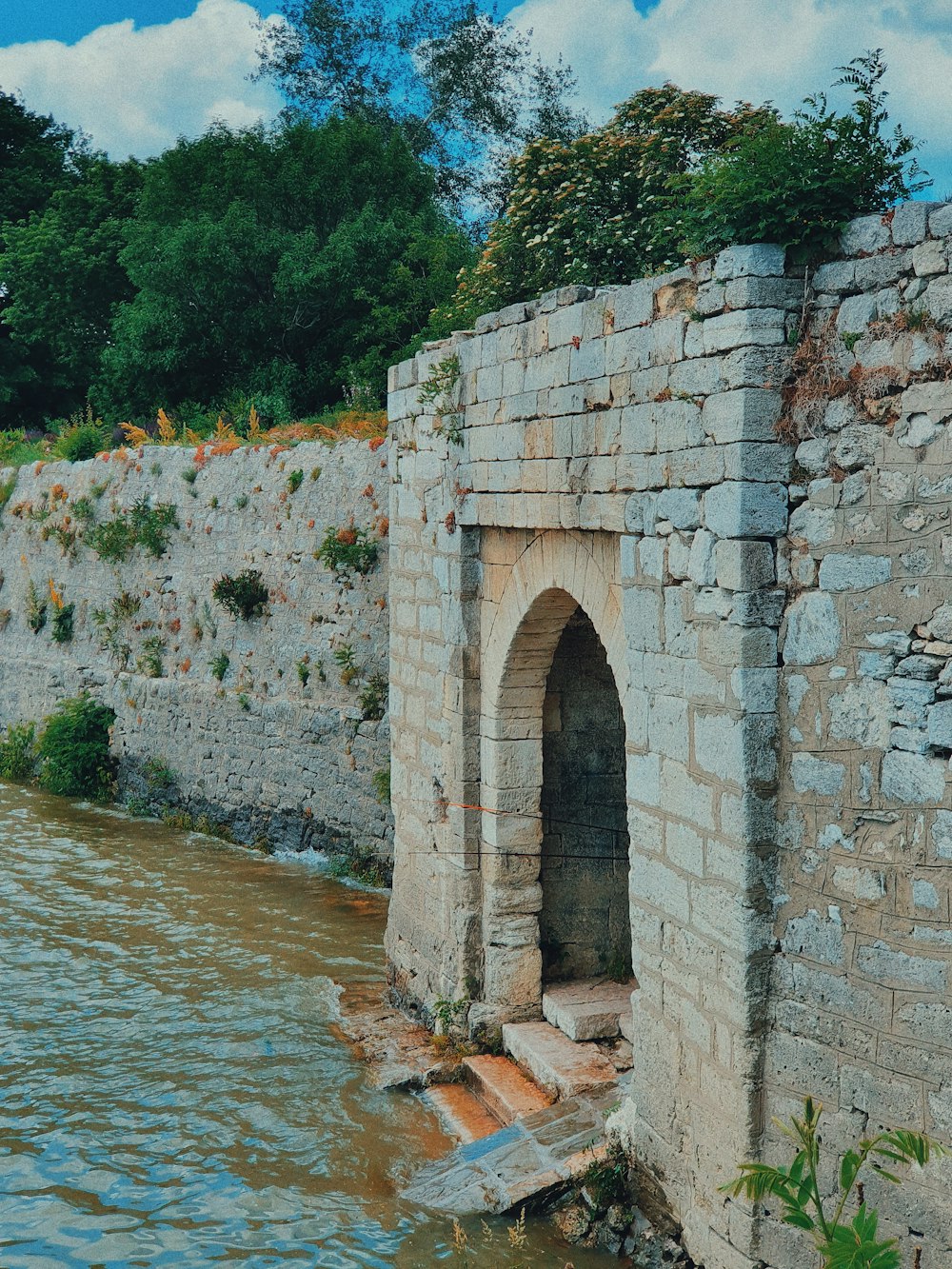 concrete archway leading to a body of water