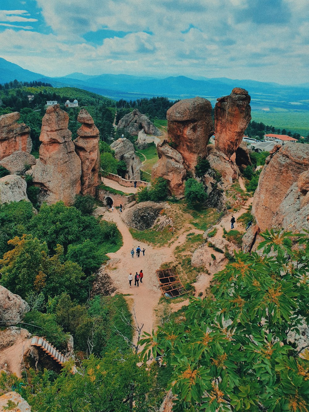 aerial photography of people surrounded by trees and rock formations