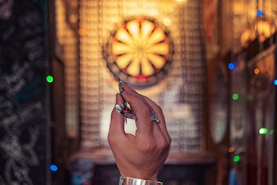 person aiming on dartboard