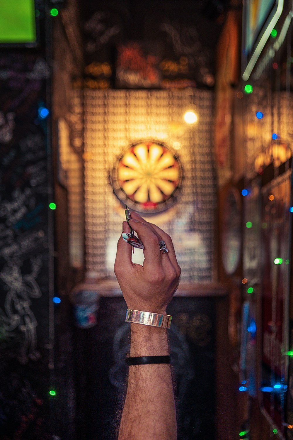 person aiming on dartboard