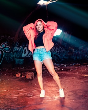 A confident woman standing tall in an urban setting, radiating strength and unapologetic energy.