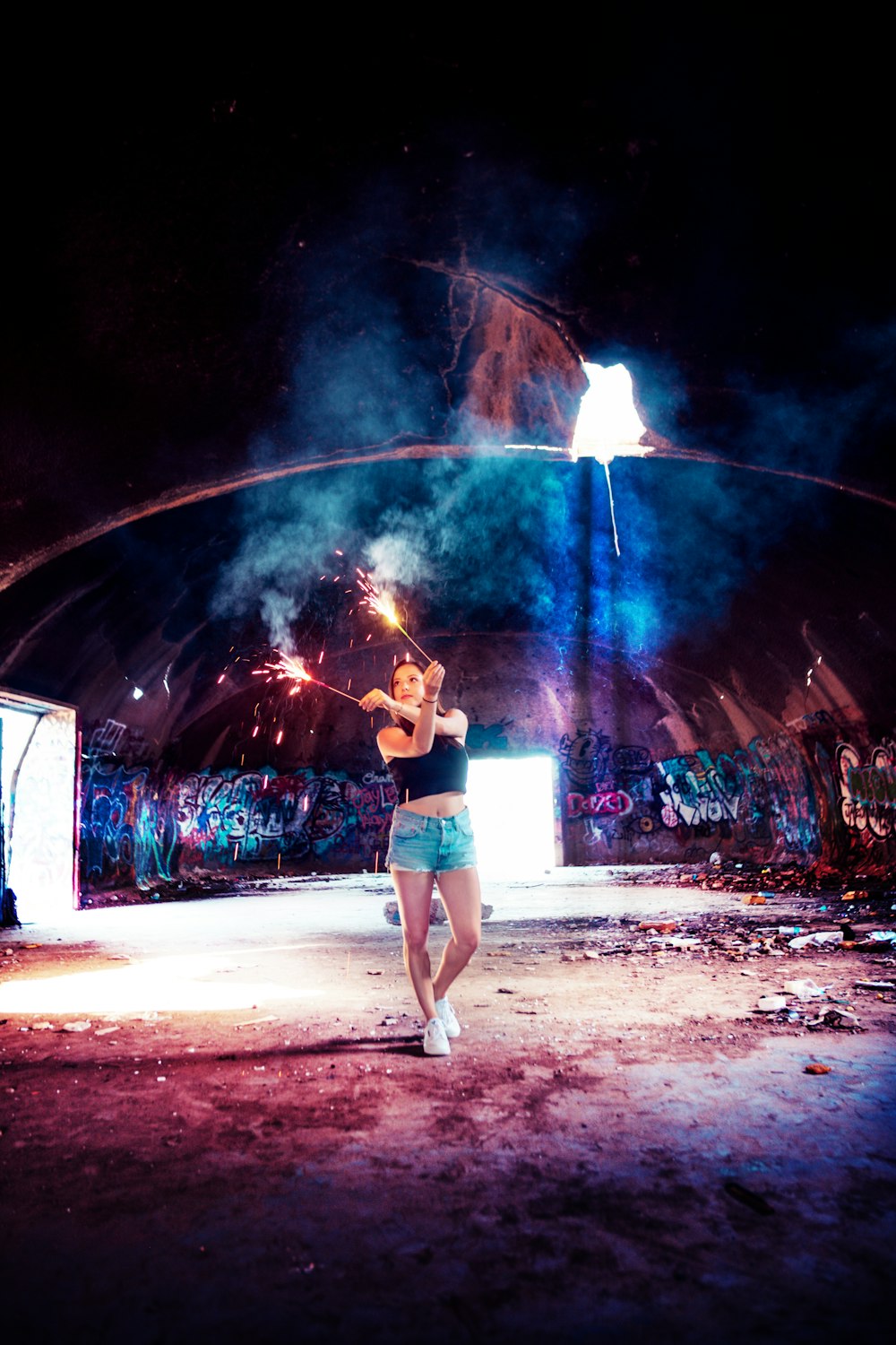 woman holding sparklers at night