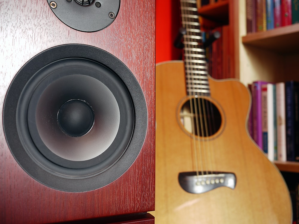 brown guitar behind speaker