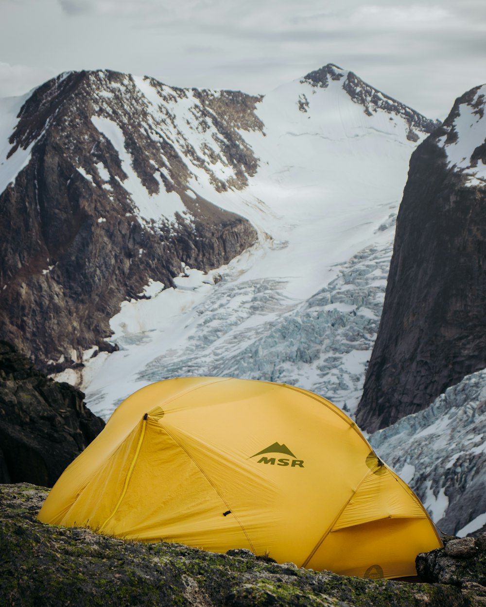 yellow camping tent near mountains during daytime