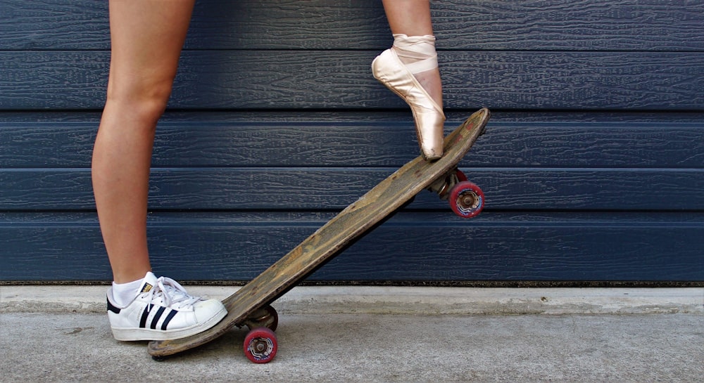 a person with a pair of ballet shoes on top of a skateboard