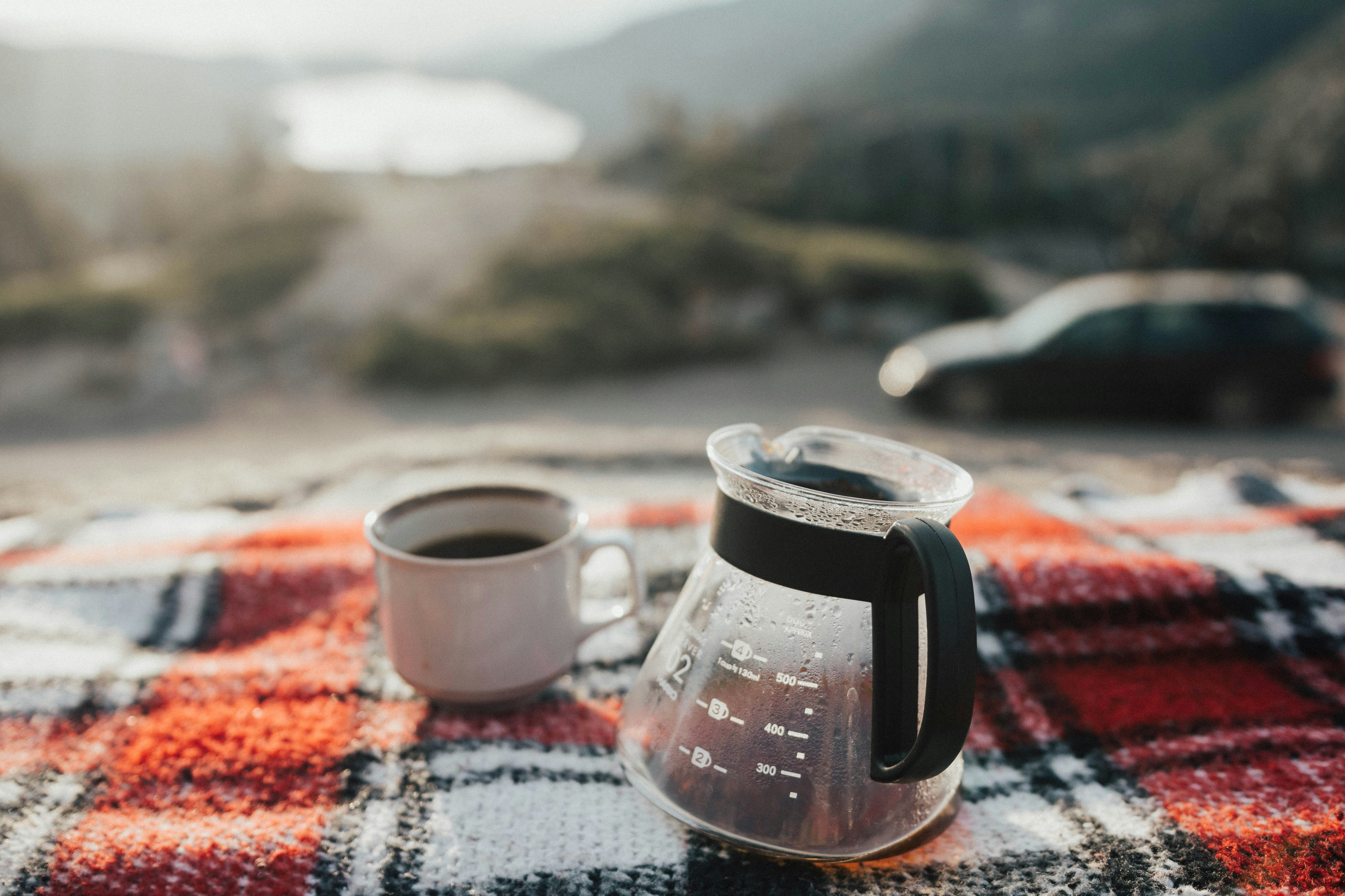 Coffee at sunrise above a lake