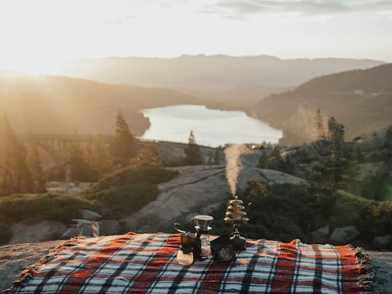 Private picnic blanket set on a secluded Santorini viewpoint