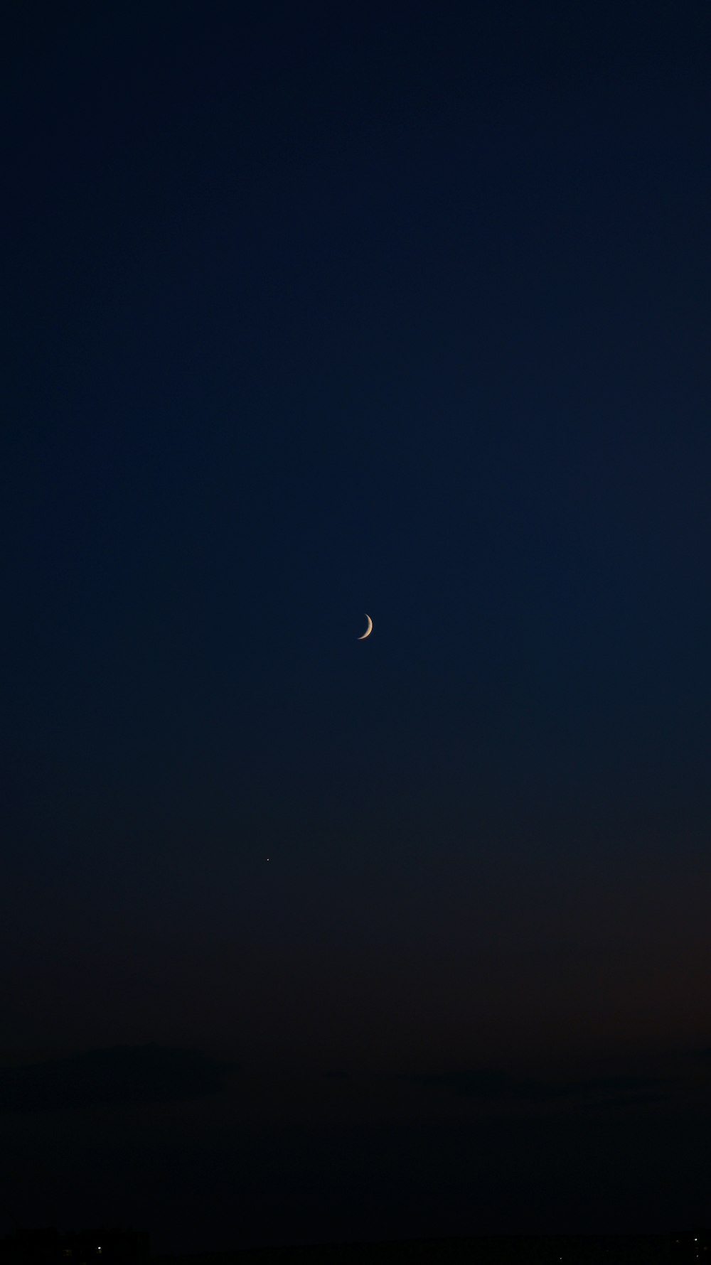 the moon is seen in the night sky