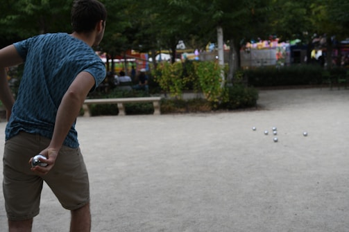 Players strategizing during a gateball match on a clear day.