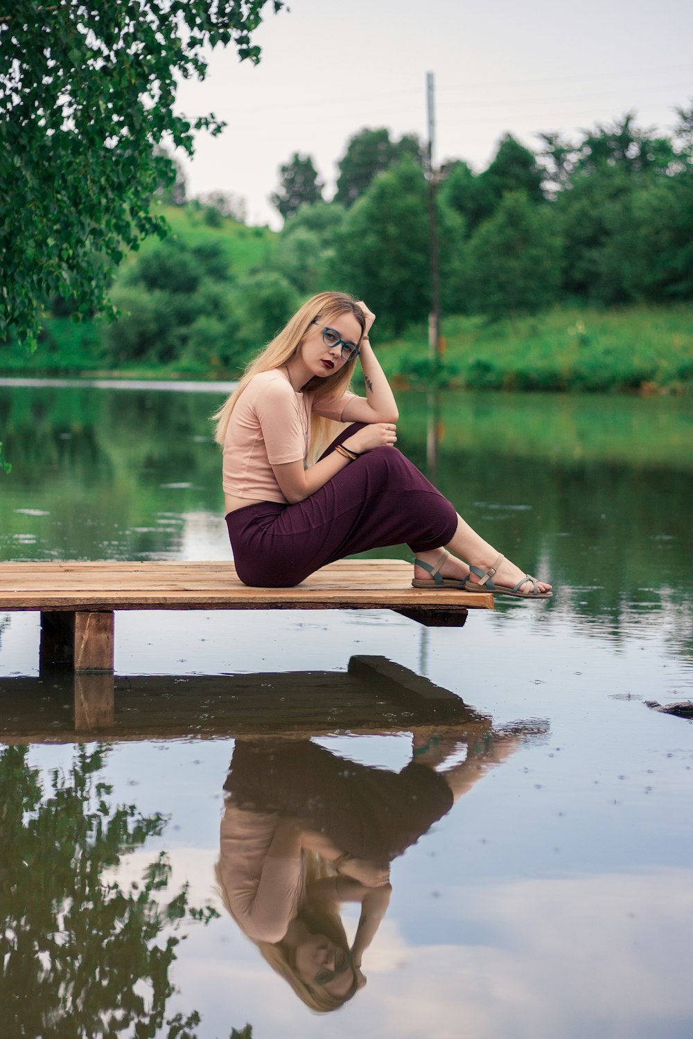 woman sitting on beach dock