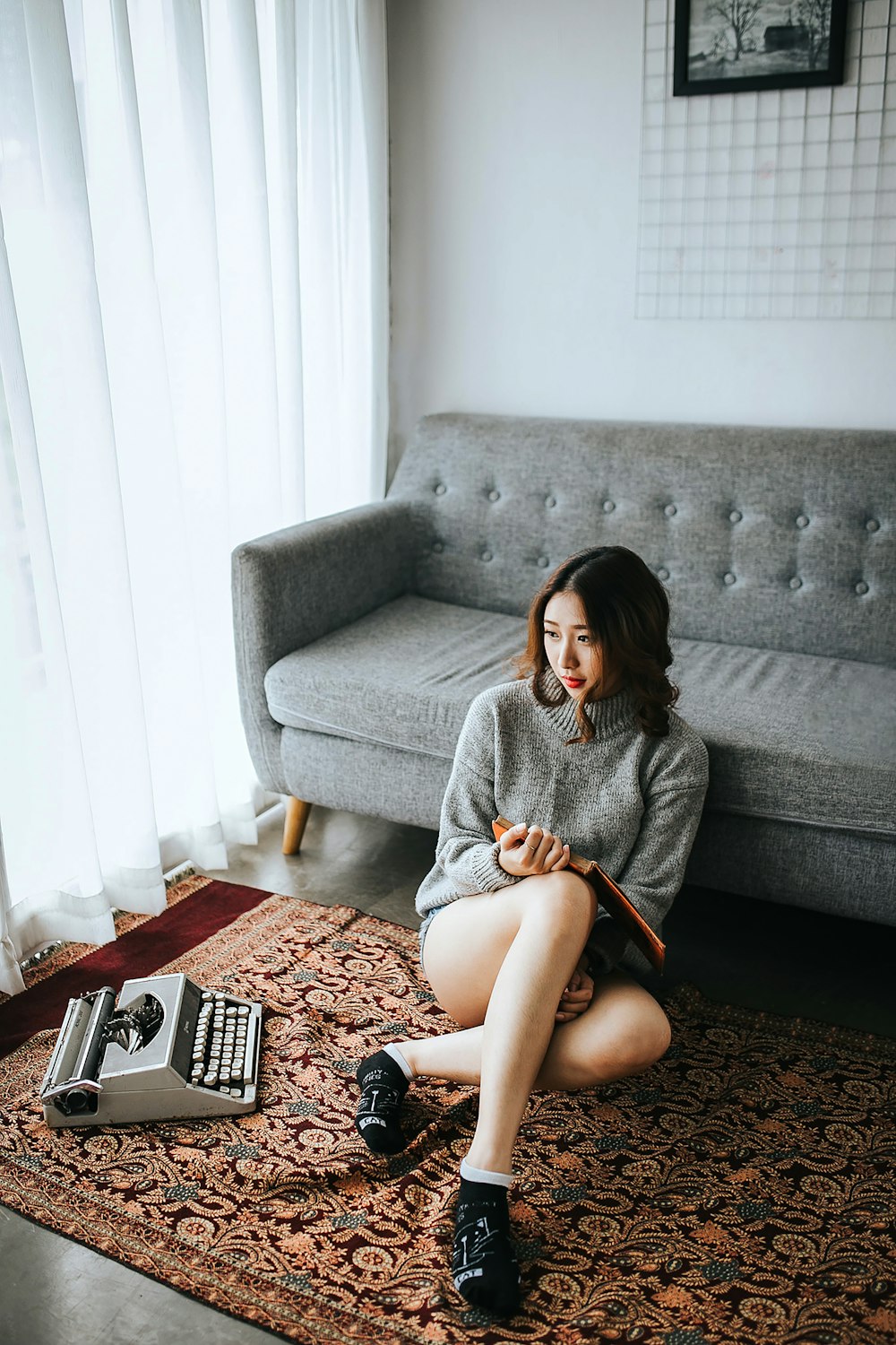 woman sitting on area rug