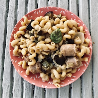 A plate of homemade pasta being served to an officer at a family-run restaurant.