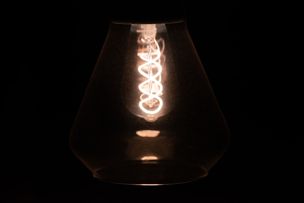 a light bulb is lit up in the dark